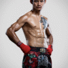 Suablack, a male Muay Thai fighter from Thailand, poses in Red SKS hand wrap and black SKS Muay Thai shorts with many sakyant patterns, showcasing his athletic build and traditional Thai boxing gear.